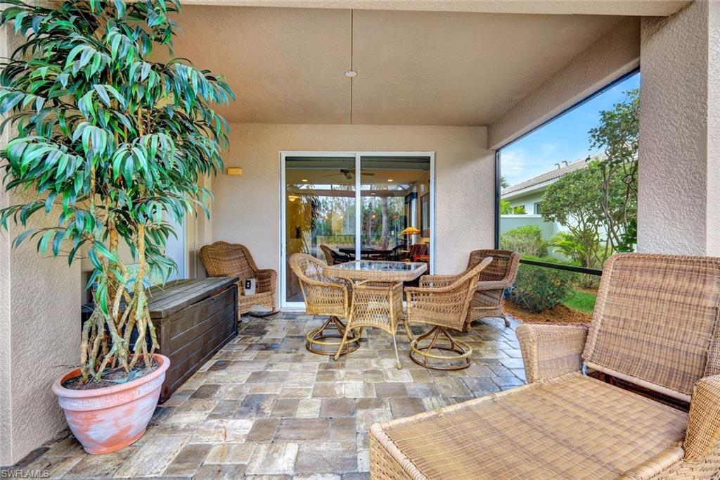 Sunroom with outdoor dining area and a patio