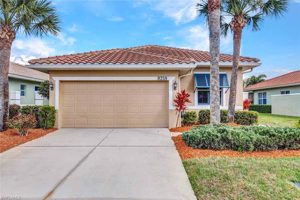 Mediterranean / spanish home with stucco siding, an attached garage, driveway, and a tile roof