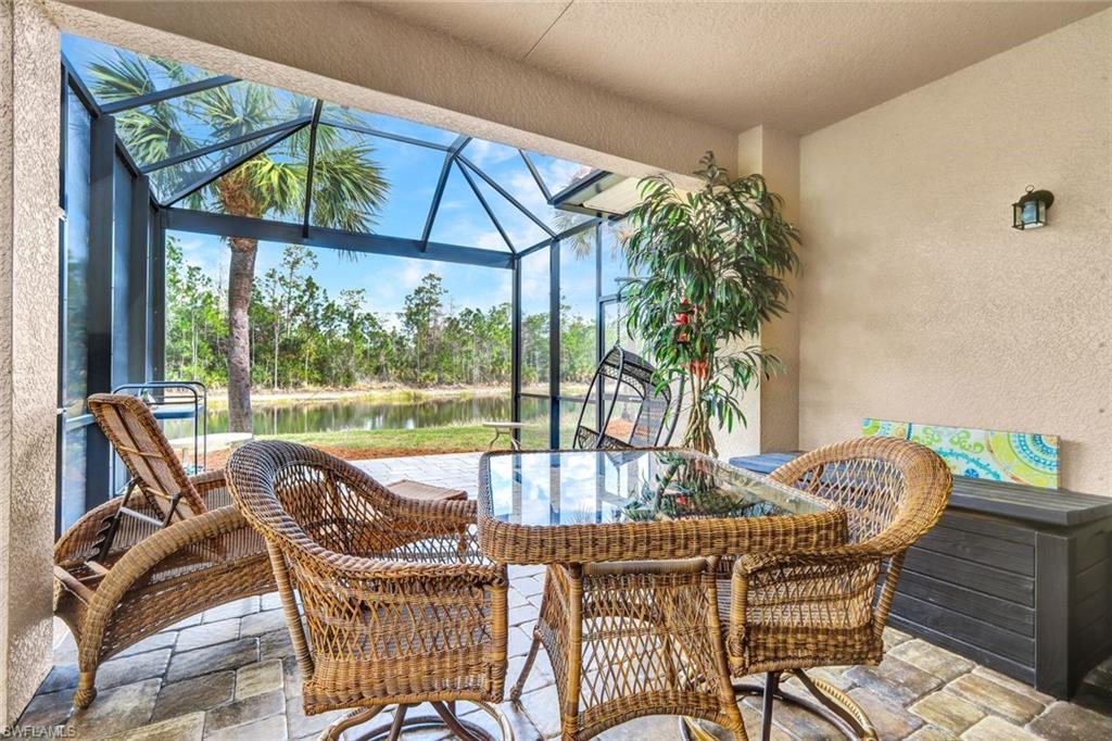 Sunroom with a patio and a water view