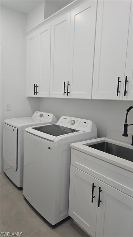 Laundry area with washer and clothes dryer and cabinet space