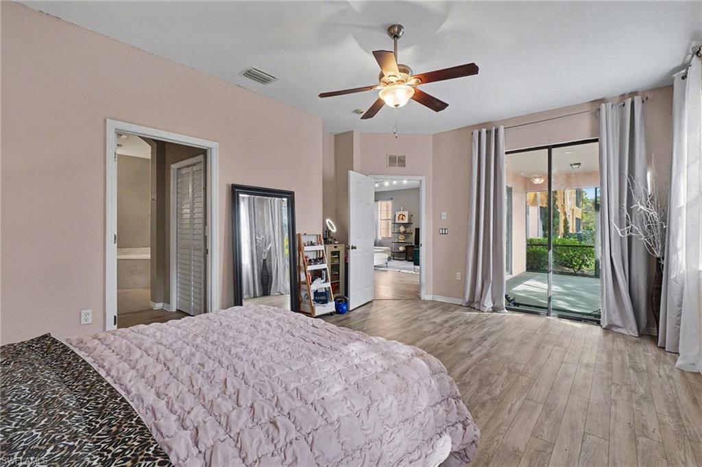 Primary Bedroom featuring light wood-style floors, access to outside, and a ceiling fan