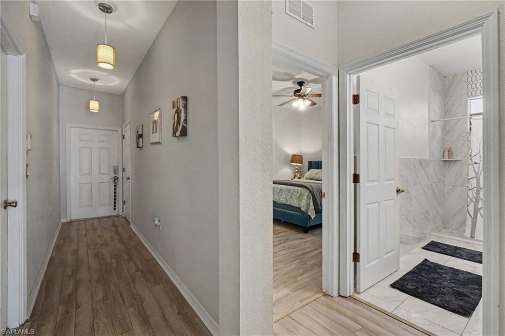 Entry Hallway featuring light wood-type flooring and a textured wall