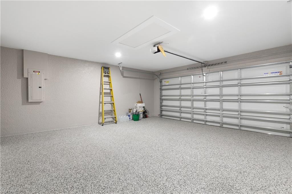 Garage featuring a textured wall and electric panel