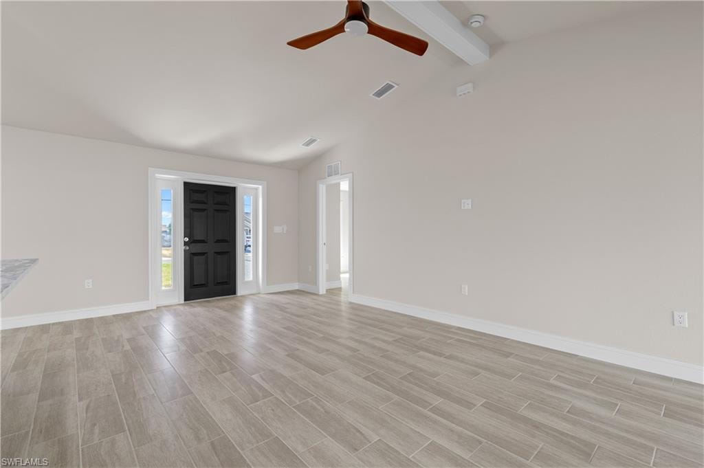 Foyer entrance with wood tiled floors, a ceiling fan, and lofted ceiling
