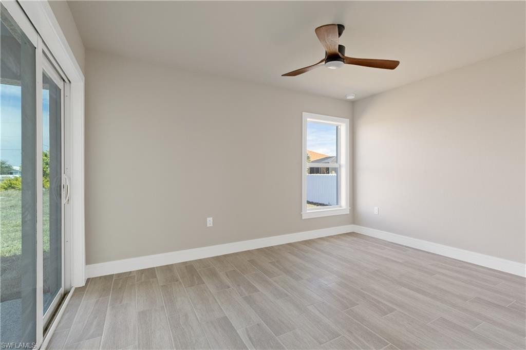 Spare room with wood tiled floors and a ceiling fan