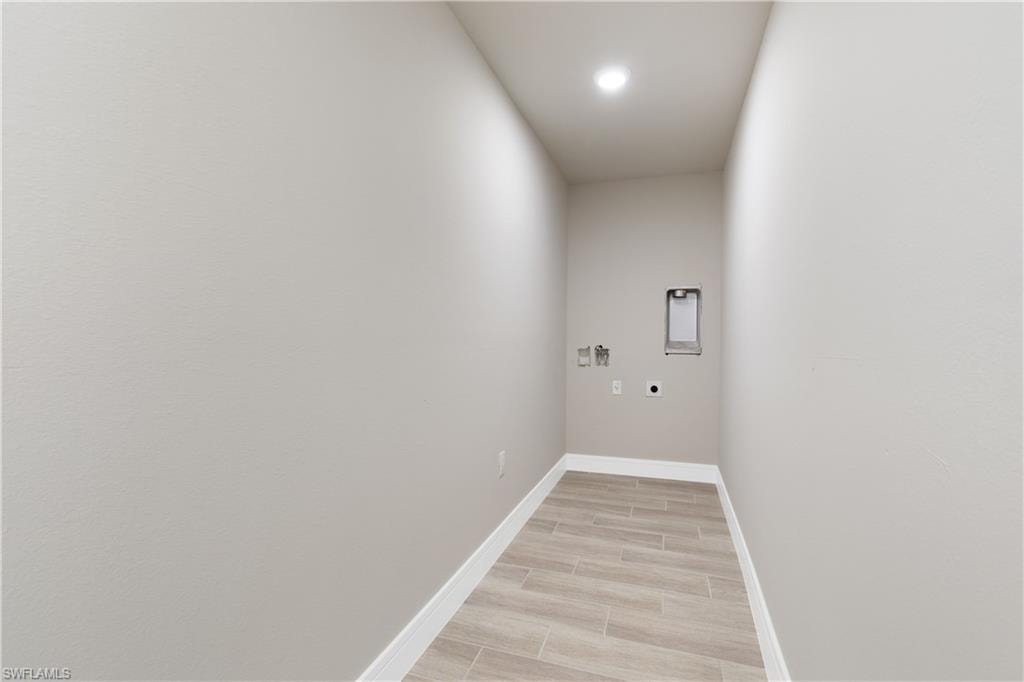 Laundry room with washer hookup, hookup for an electric dryer, wood tiled floors, and recessed lighting