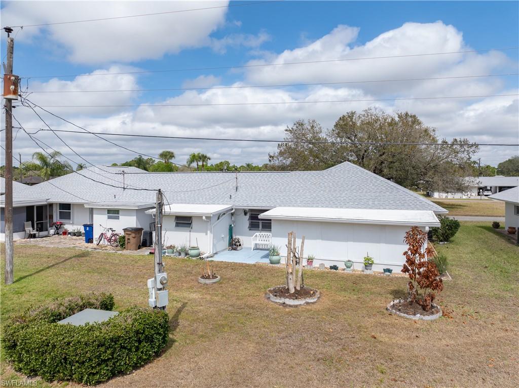 Single story home featuring a front lawn and roof with shingles