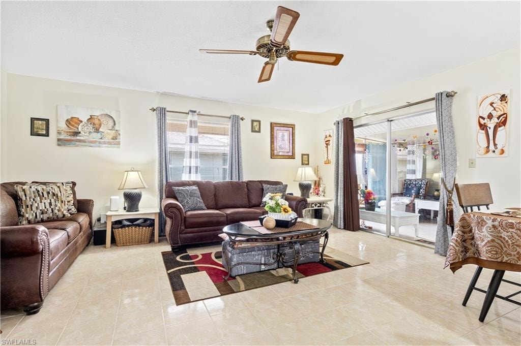 Living room featuring ceiling fan and light tile patterned flooring