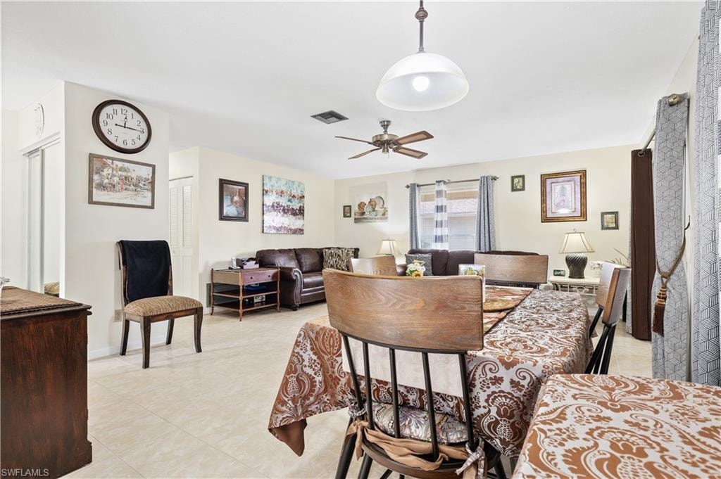 Dining area featuring ceiling fan and light tile patterned floors
