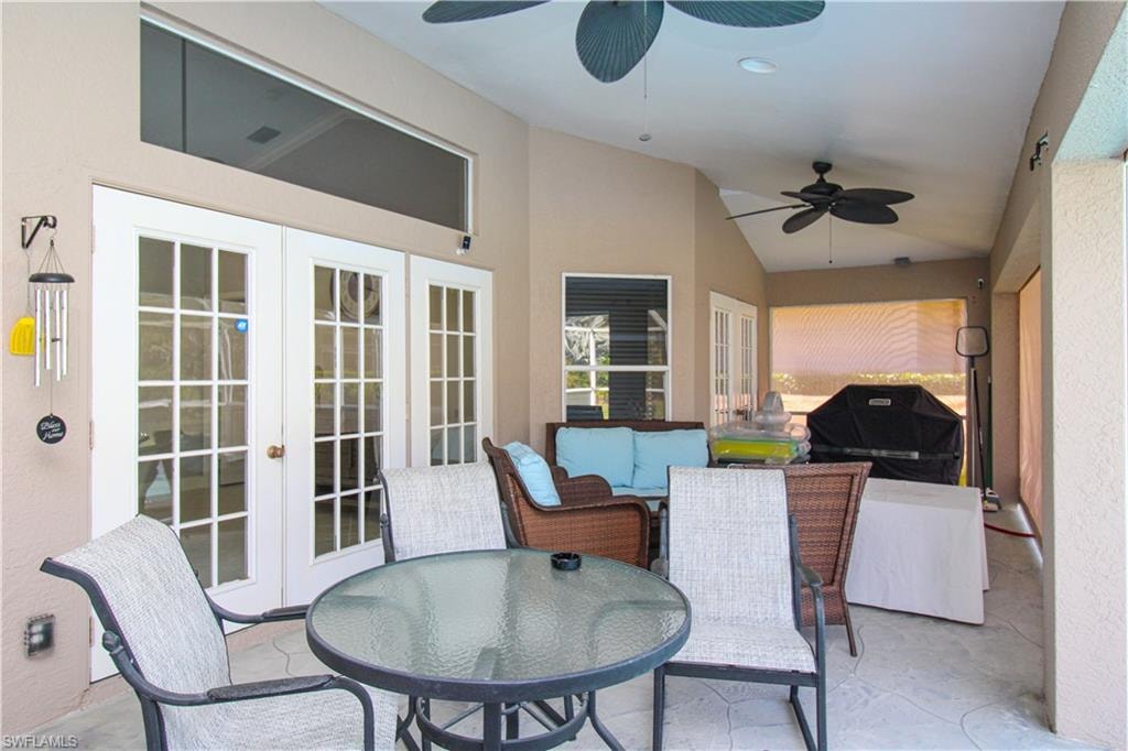 View of patio featuring ceiling fan, french doors, grilling area, and outdoor dining space