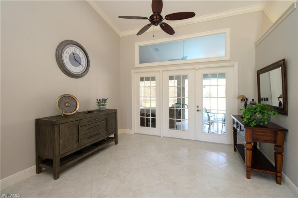 Doorway to outside featuring a ceiling fan, french doors, baseboards, and ornamental molding