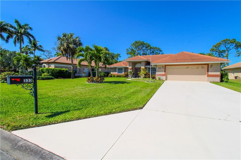 Single story home with a front yard, an attached garage, stucco siding, concrete driveway, and a tiled roof