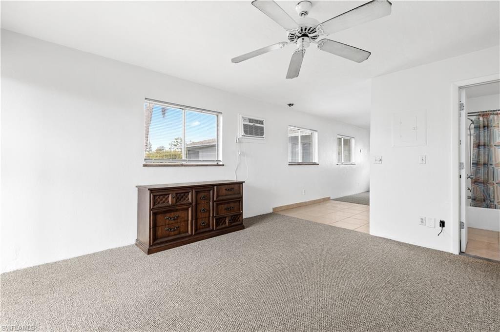 Spare room with light carpet and a ceiling fan
