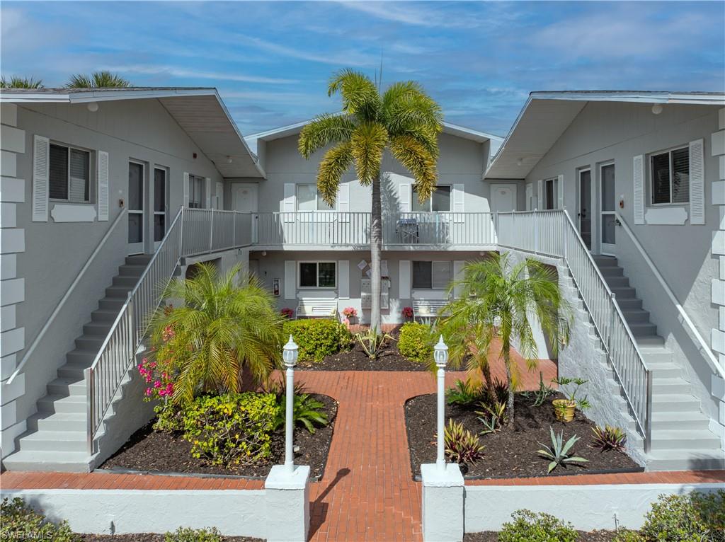 View of home's community with stairway and a balcony