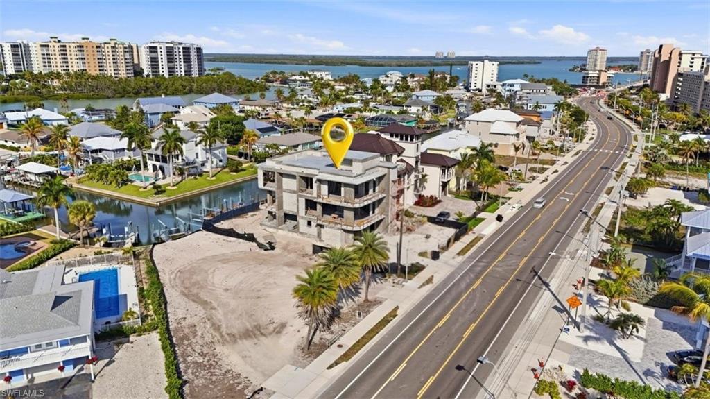 Drone / aerial view of a large body of water and apartment complex - Virtually Edited Image