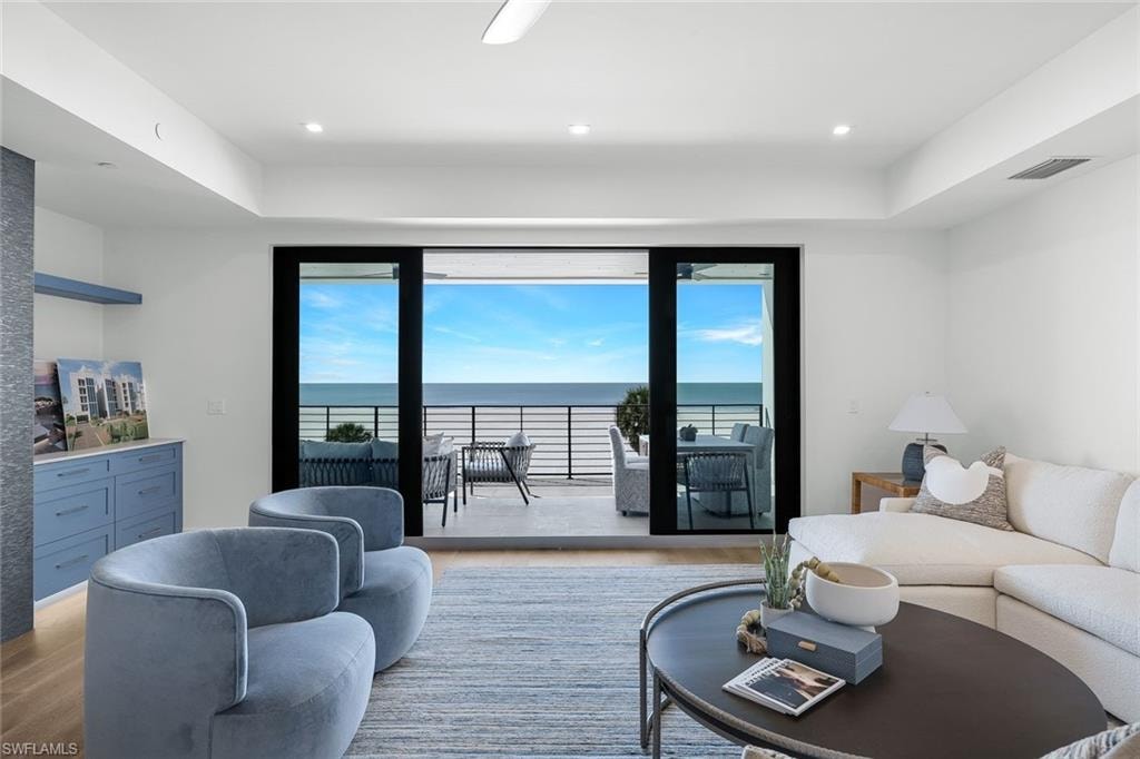 Living area featuring a water view and wood finished floors
