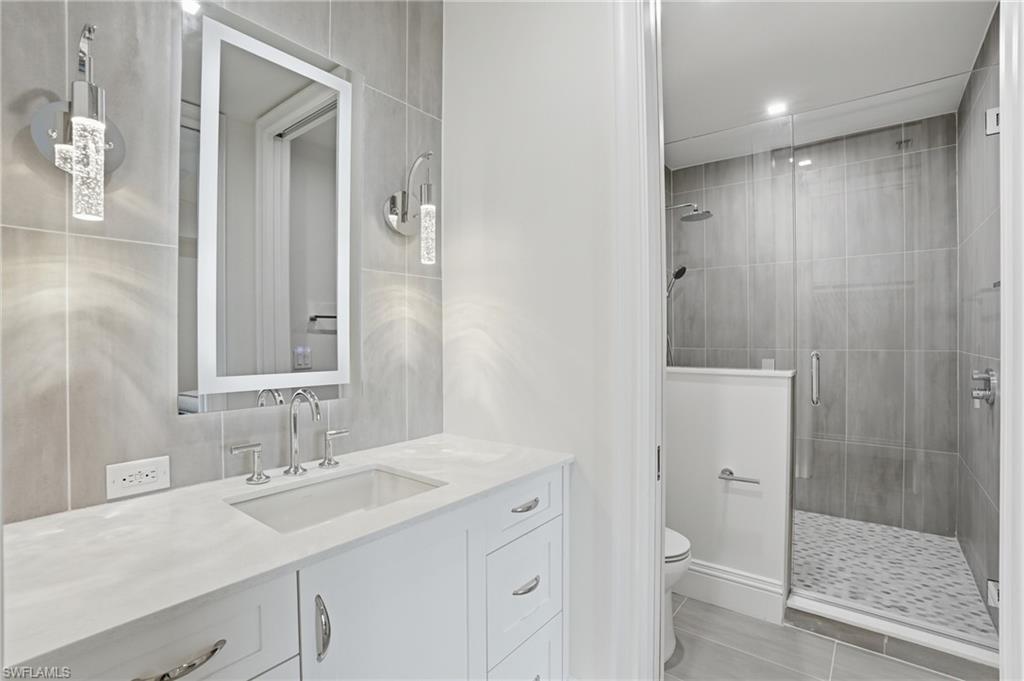 Full bath with vanity and a stall shower