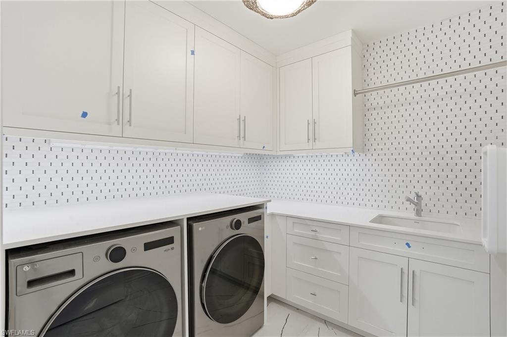 Laundry room featuring cabinet space and washer and dryer