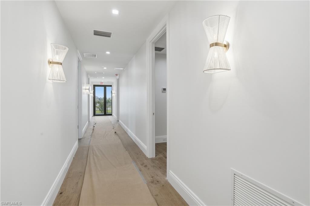 Hallway featuring light wood-style floors and recessed lighting