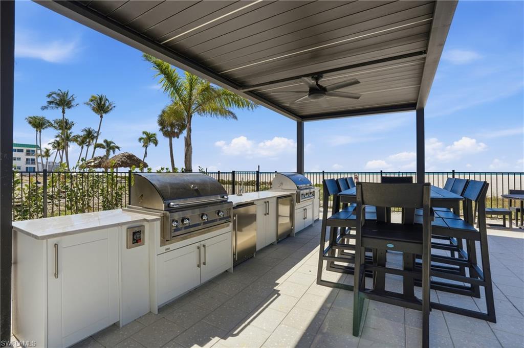View of patio / terrace with an outdoor kitchen / dining area and a ceiling fan