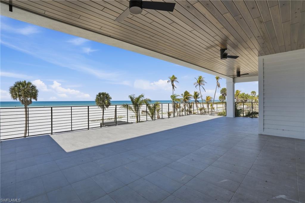 View of patio / terrace with a ceiling fan and a water view