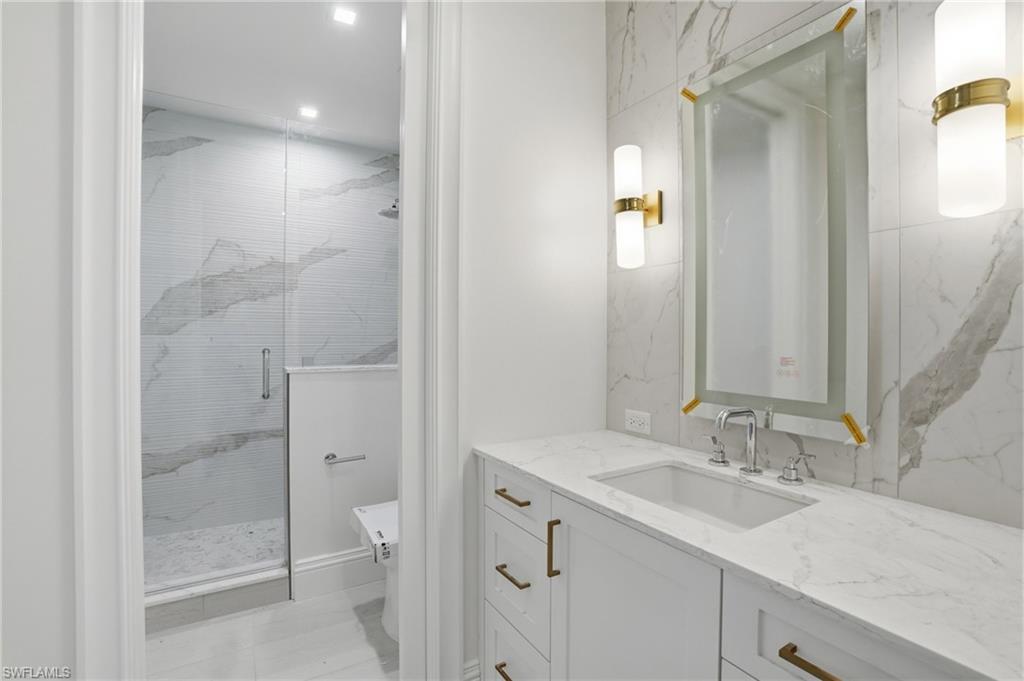 Bathroom with vanity and a stall shower
