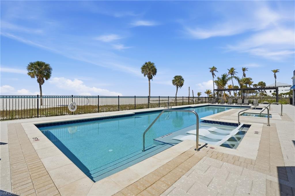 Community pool with a patio area and a community hot tub