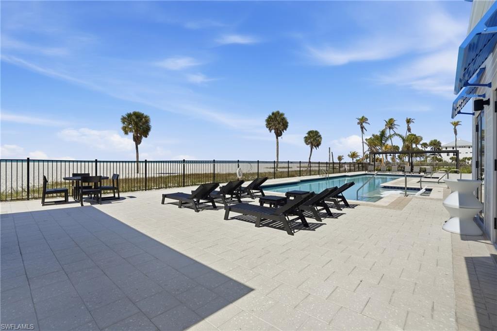 Community pool with a patio