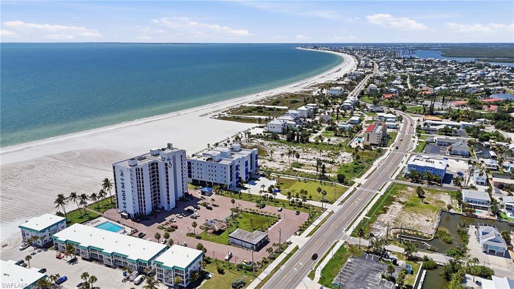 Coastal residential area featuring direct beachfront access and aquatic amenities - Virtually Edited Image