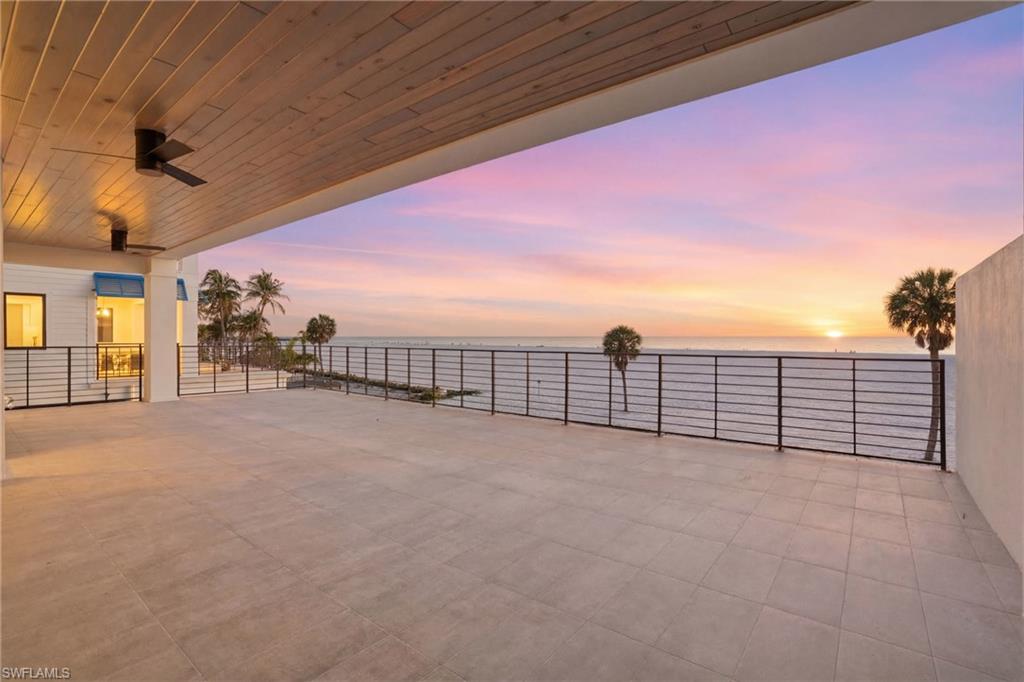 View of patio / terrace with ceiling fan and a water view
