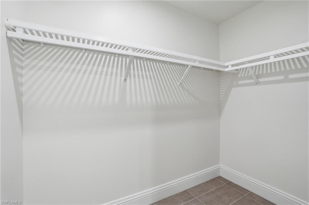 Walk in closet featuring light tile patterned flooring