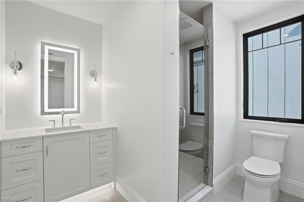 Full bath with vanity and a shower stall