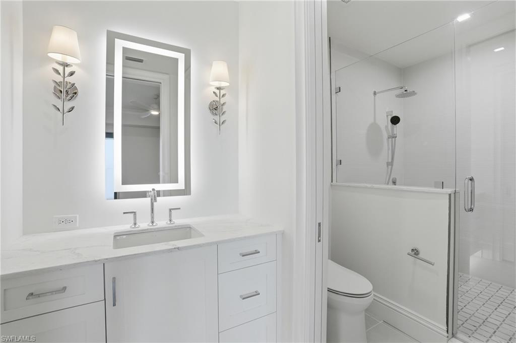 Bathroom featuring a shower stall, vanity, and light tile patterned floors