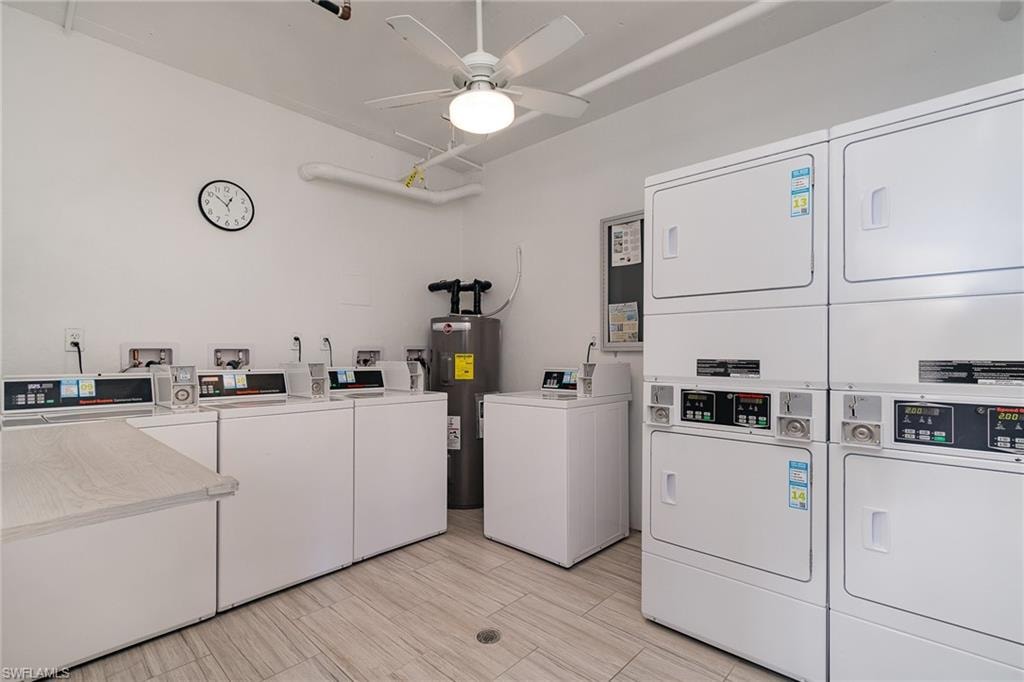 Shared laundry with water heater, a ceiling fan, stacked washer / drying machine, and washing machine and clothes dryer