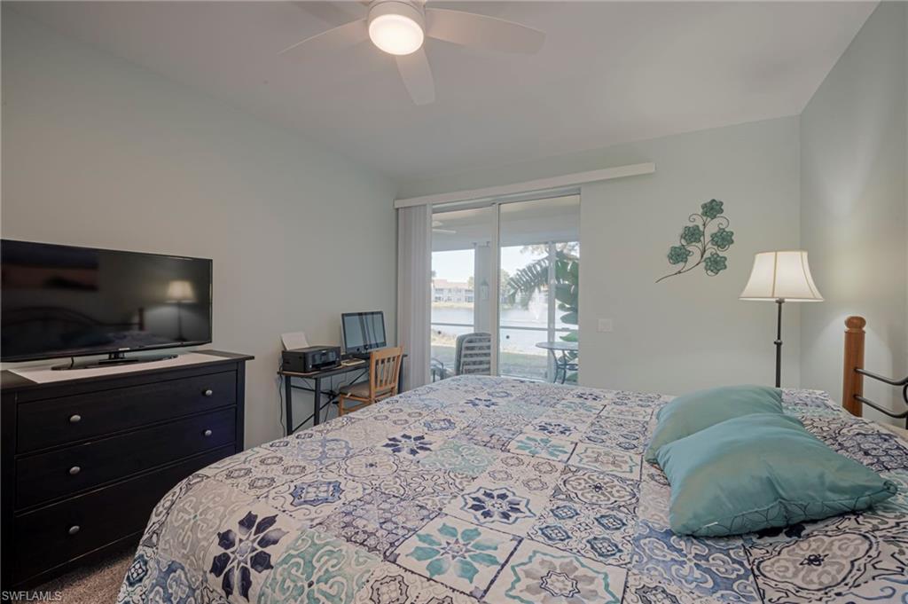 Carpeted bedroom with access to exterior and a ceiling fan