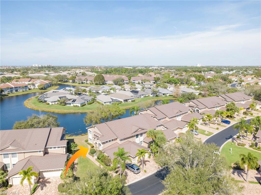 Aerial view of residential area featuring a nearby body of water