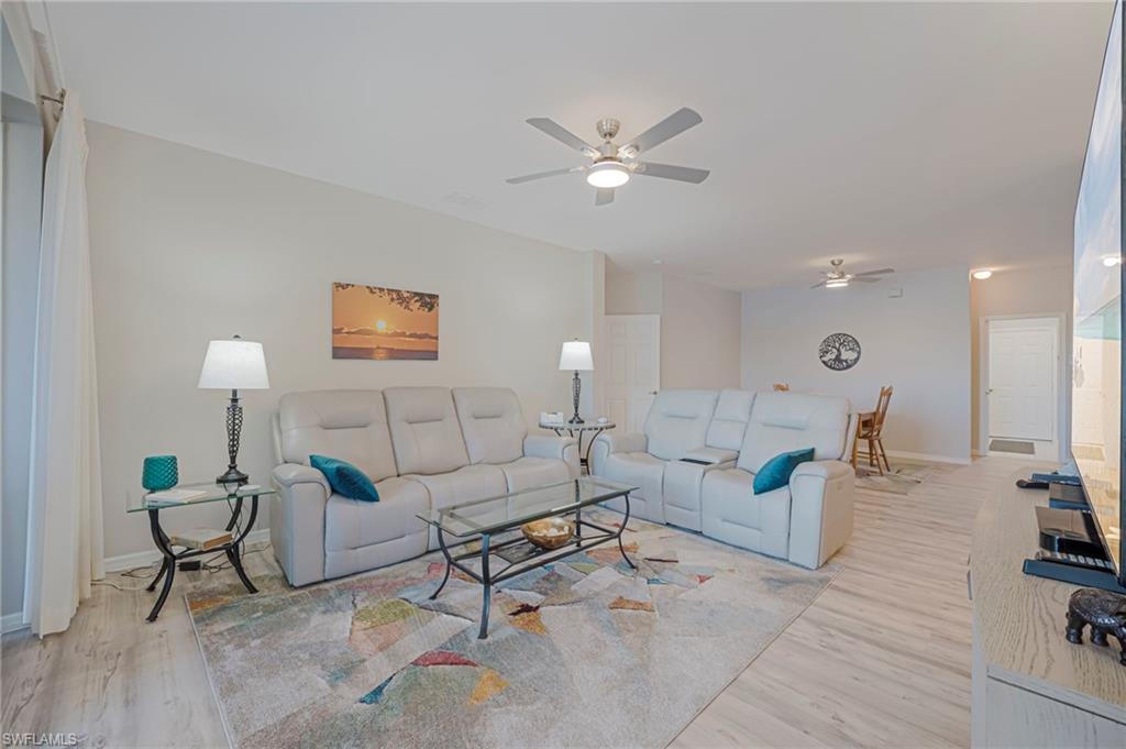 Living area featuring ceiling fan and light wood-style floors