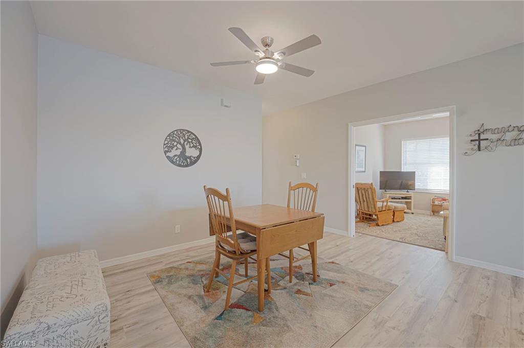Dining room with light wood-style flooring and ceiling fan