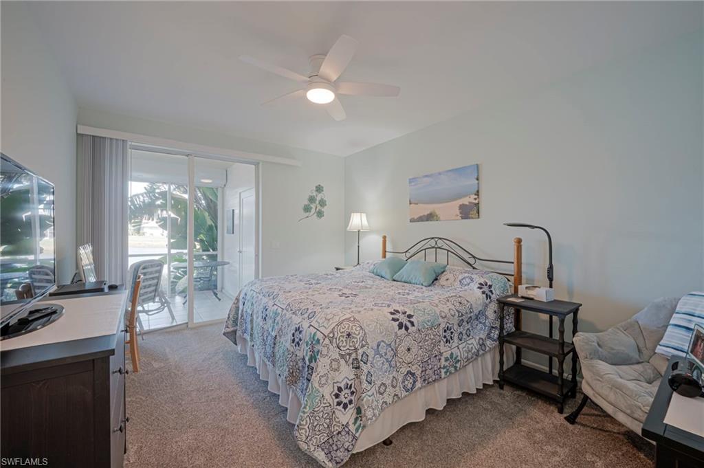 Bedroom featuring light carpet, access to outside, and ceiling fan