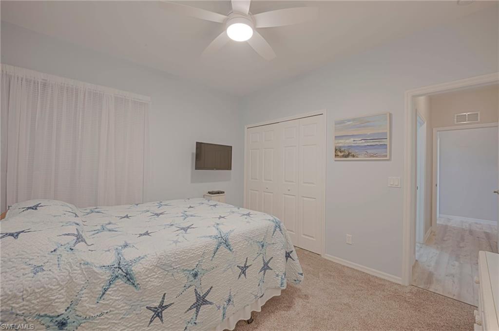 Bedroom with carpet floors, a closet, and ceiling fan
