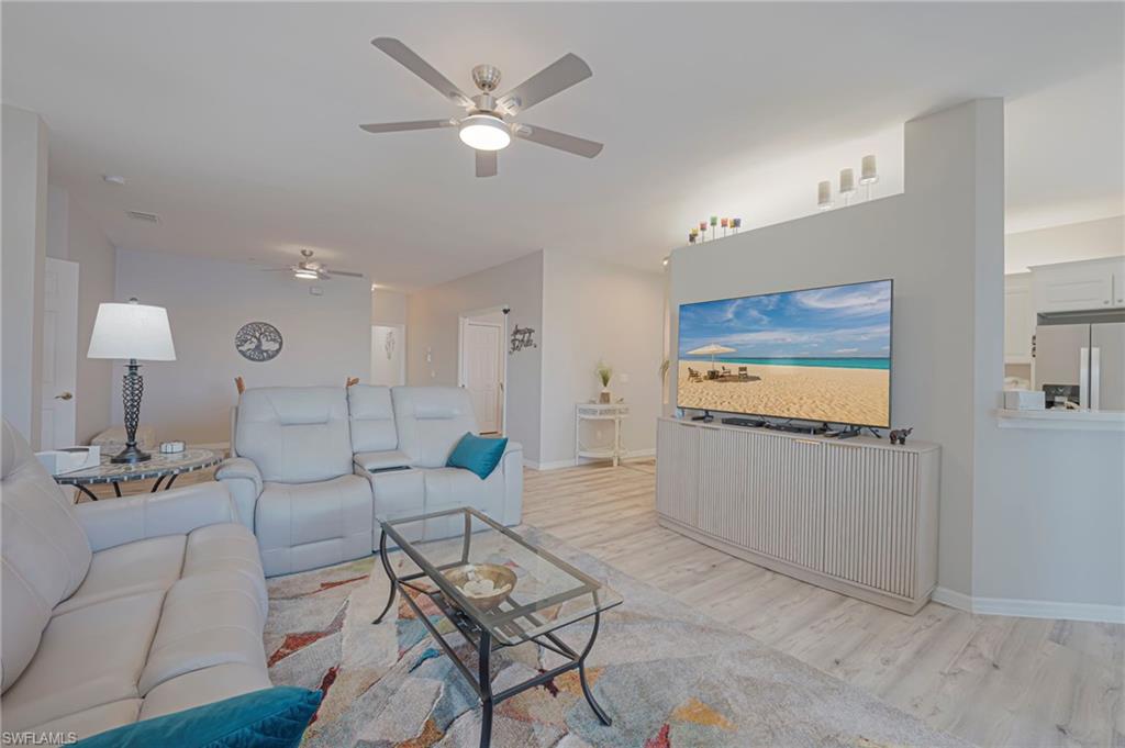 Living area featuring light wood-type flooring and ceiling fan