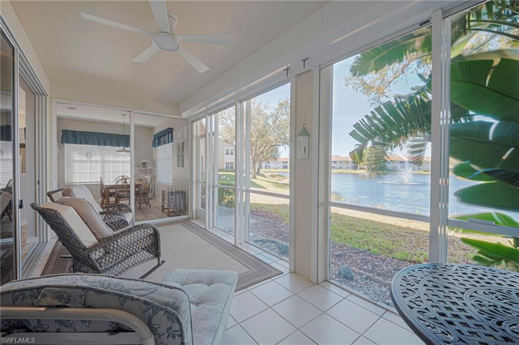 Sunroom featuring ceiling fan and a water view