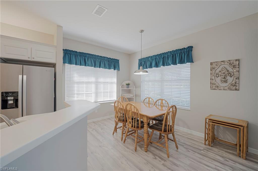 Dining space featuring light wood-style flooring and baseboards