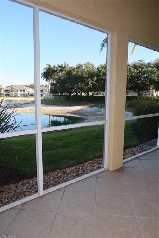 Screened patio with tile flooring and a water feature
