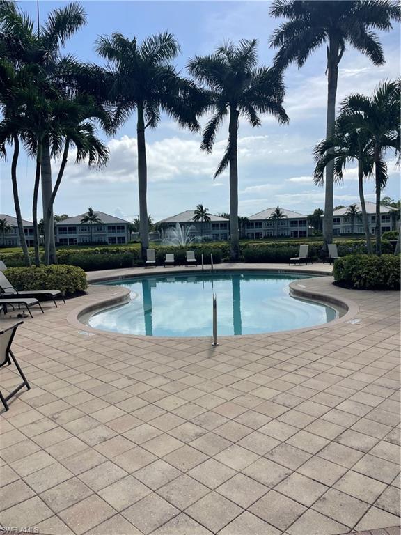 Community pool with a patio