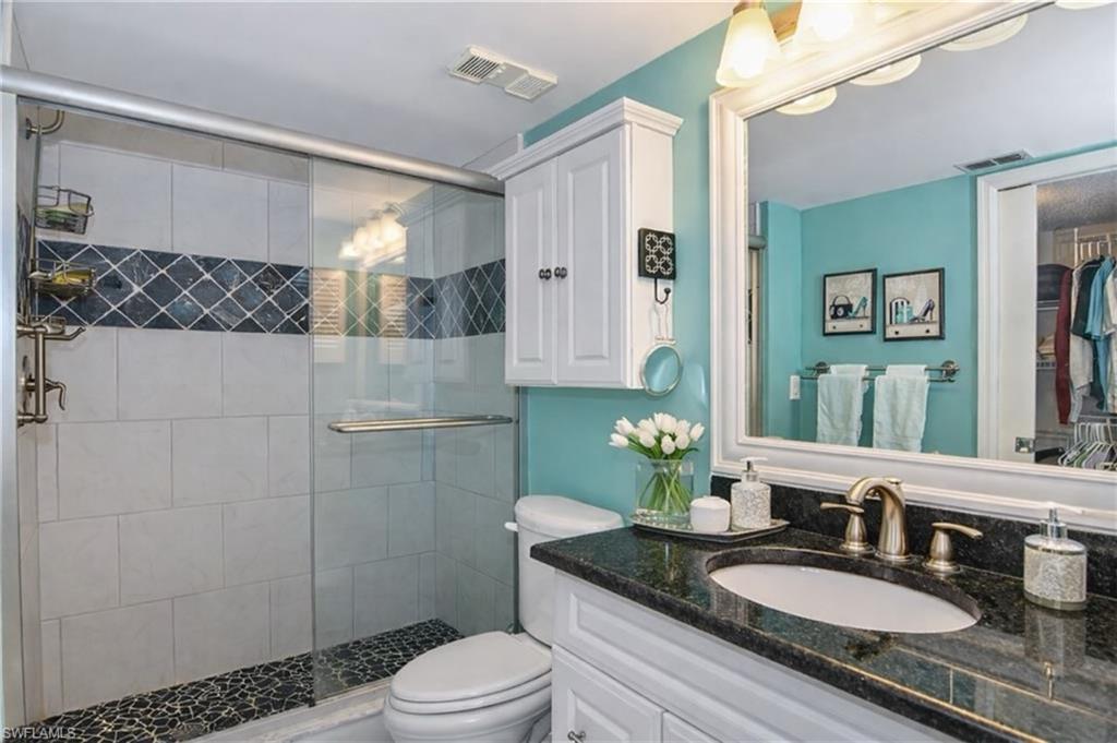 Full bathroom featuring vanity and a stall shower
