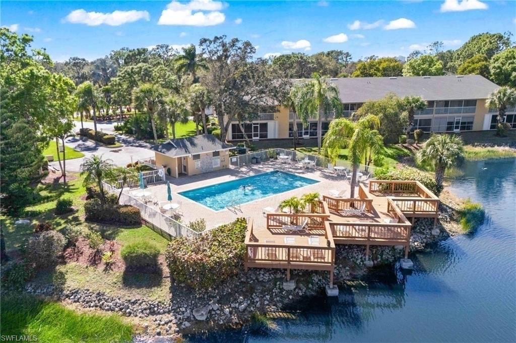 Community pool with a patio and a water view