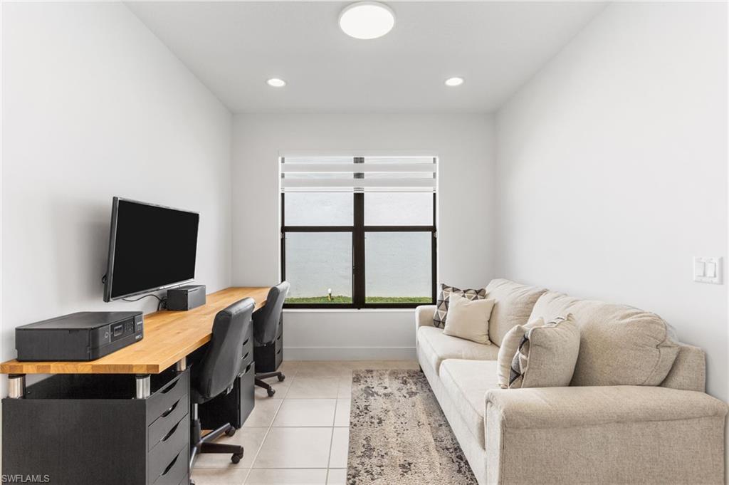 Office featuring light tile patterned floors and recessed lighting