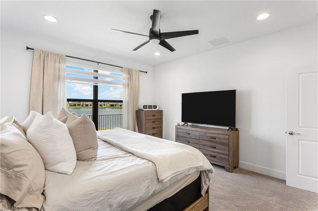 Bedroom featuring access to outside, ceiling fan, light carpet, and recessed lighting