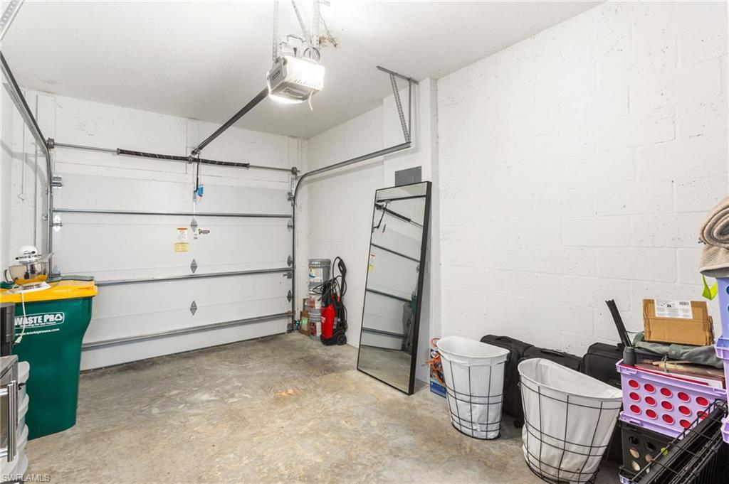 Garage with a garage door opener and concrete block wall